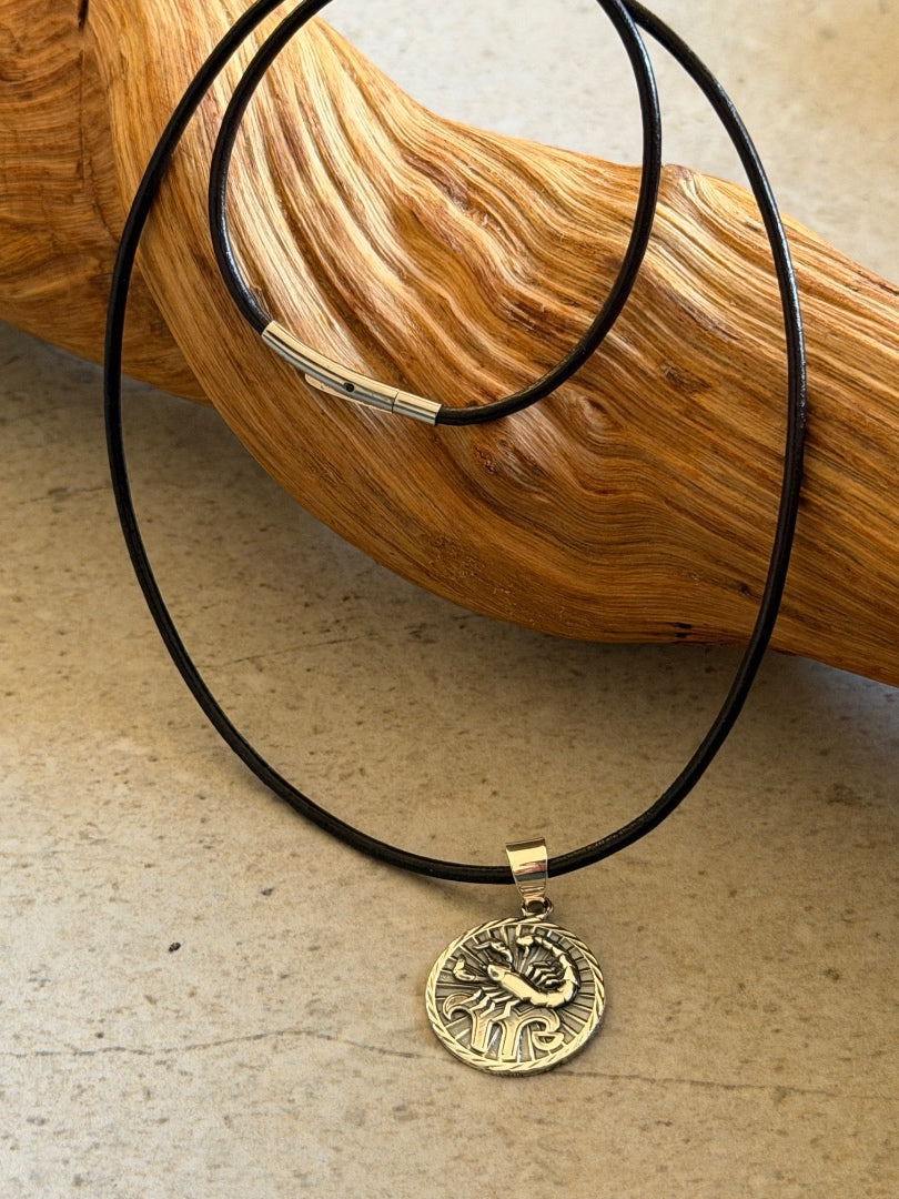 Necklace with a gold pendant on a wooden surface