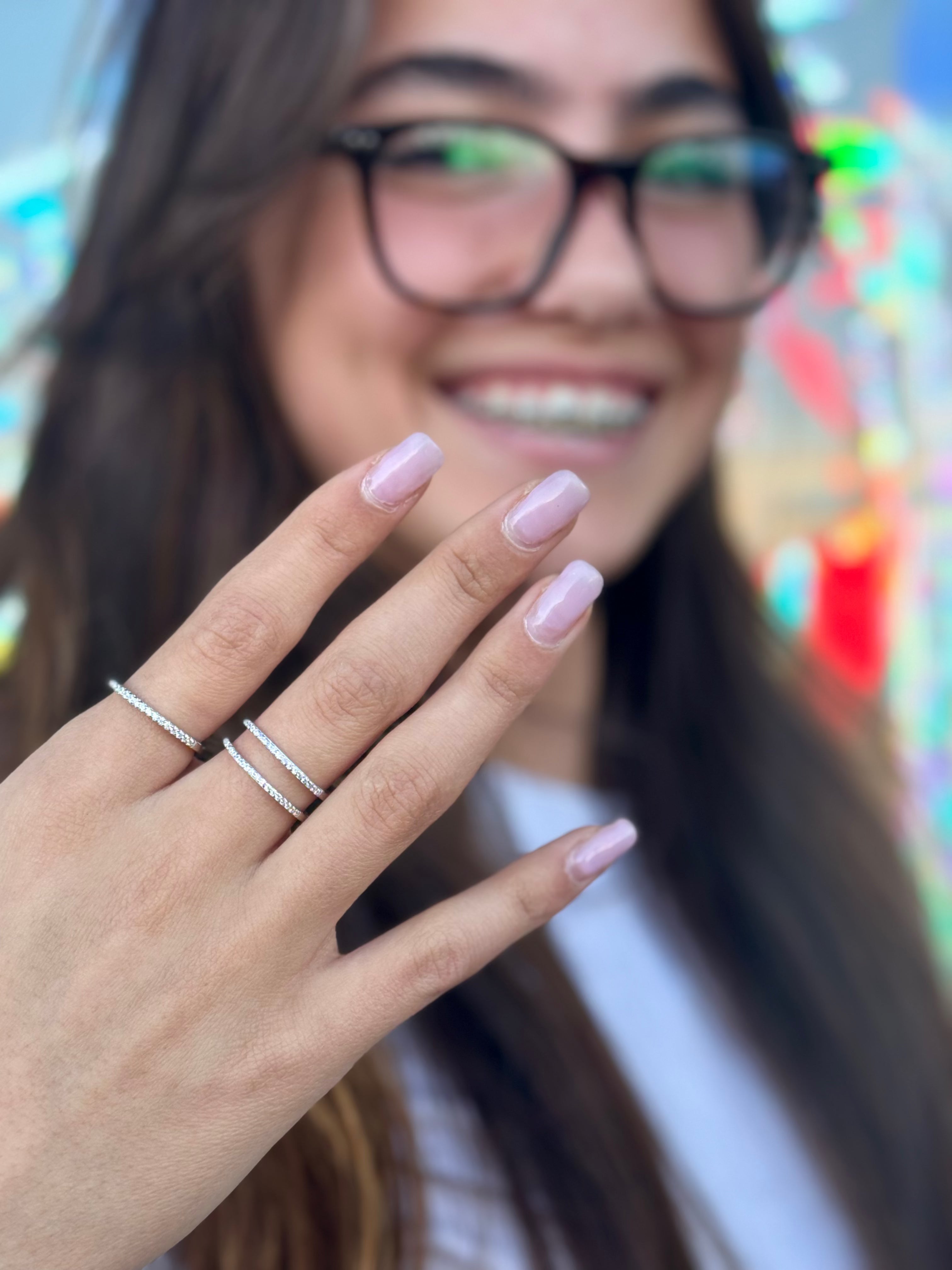 Person wearing glasses with a blurred colorful background