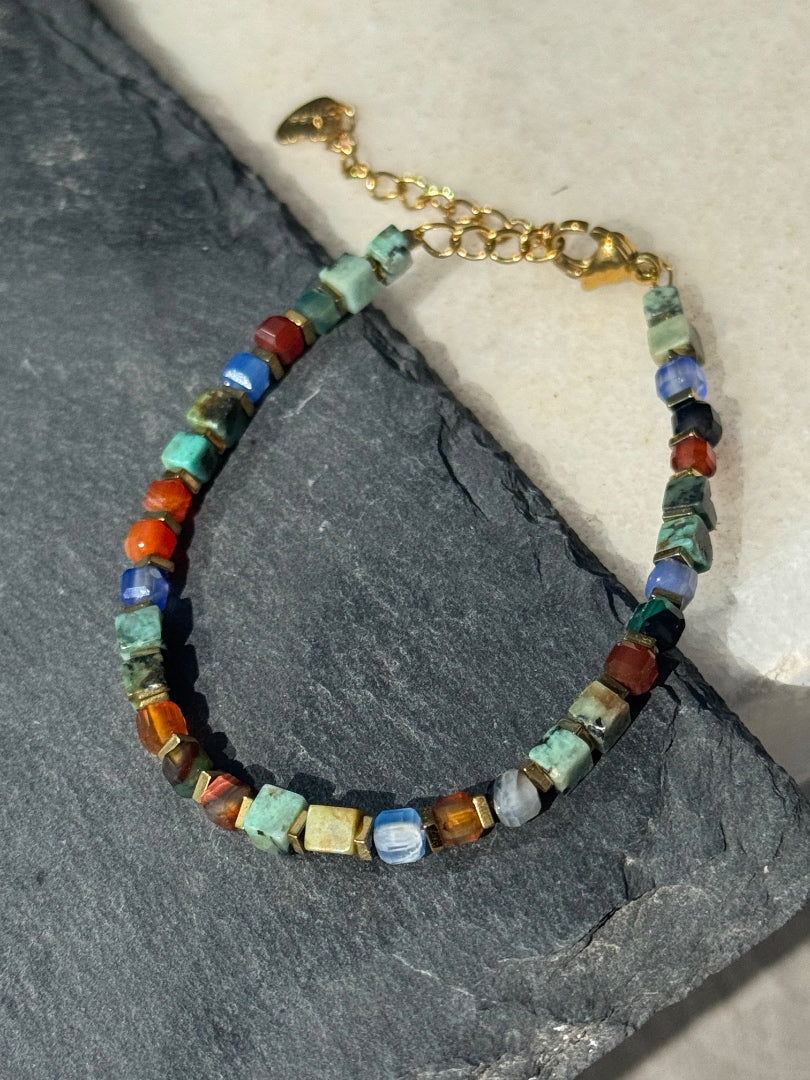Multicolored beaded bracelet on a stone surface