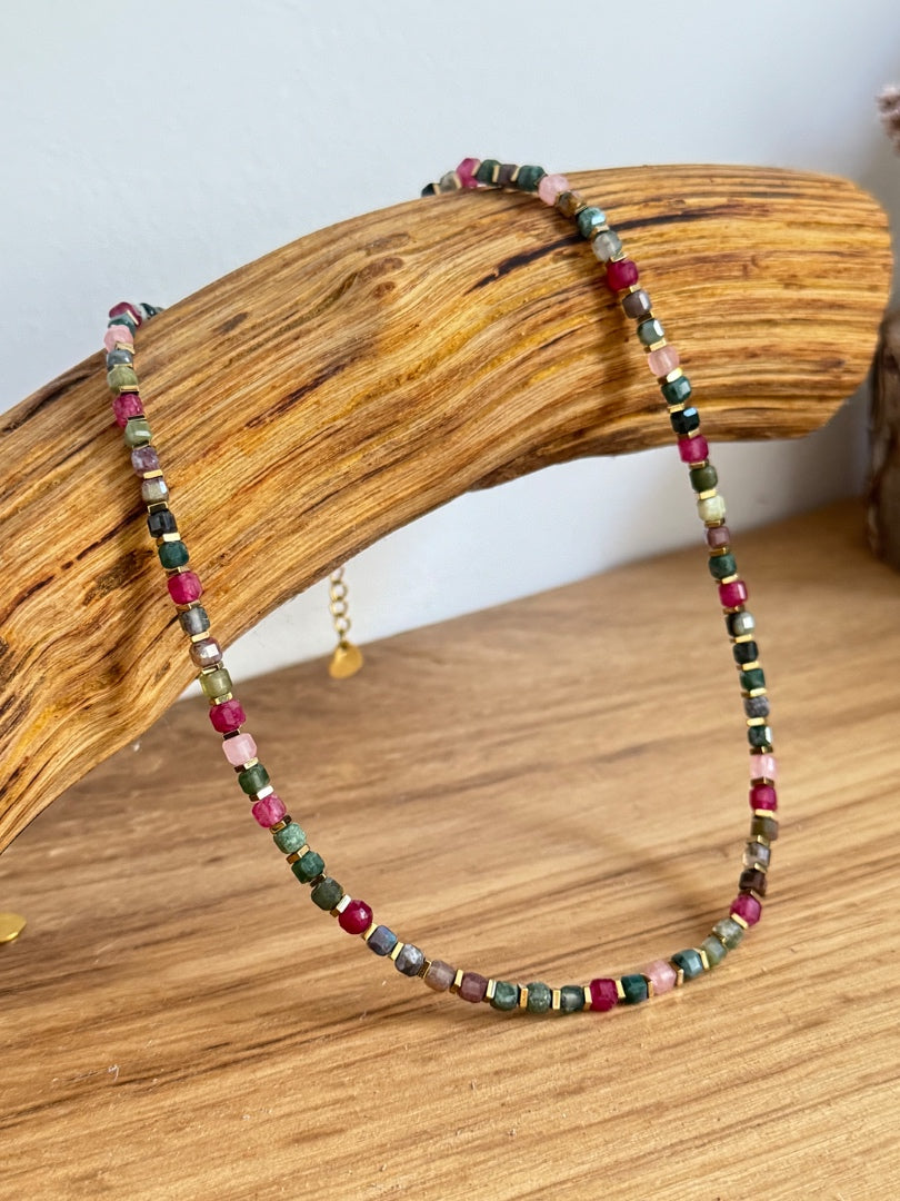 Multicolored beaded necklace on a wooden surface