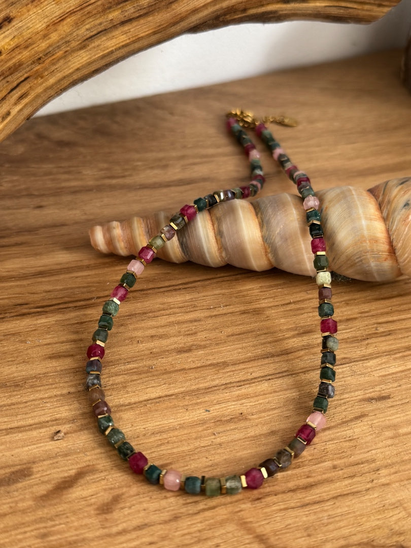 Multicolored beaded necklace on a wooden surface