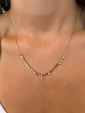 Gold necklace with small beads on a person's neck