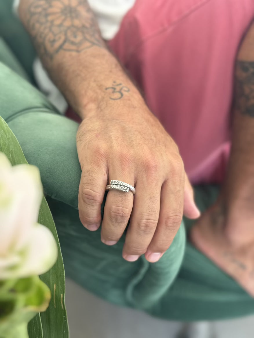 Hand wearing a ring with a blurred background