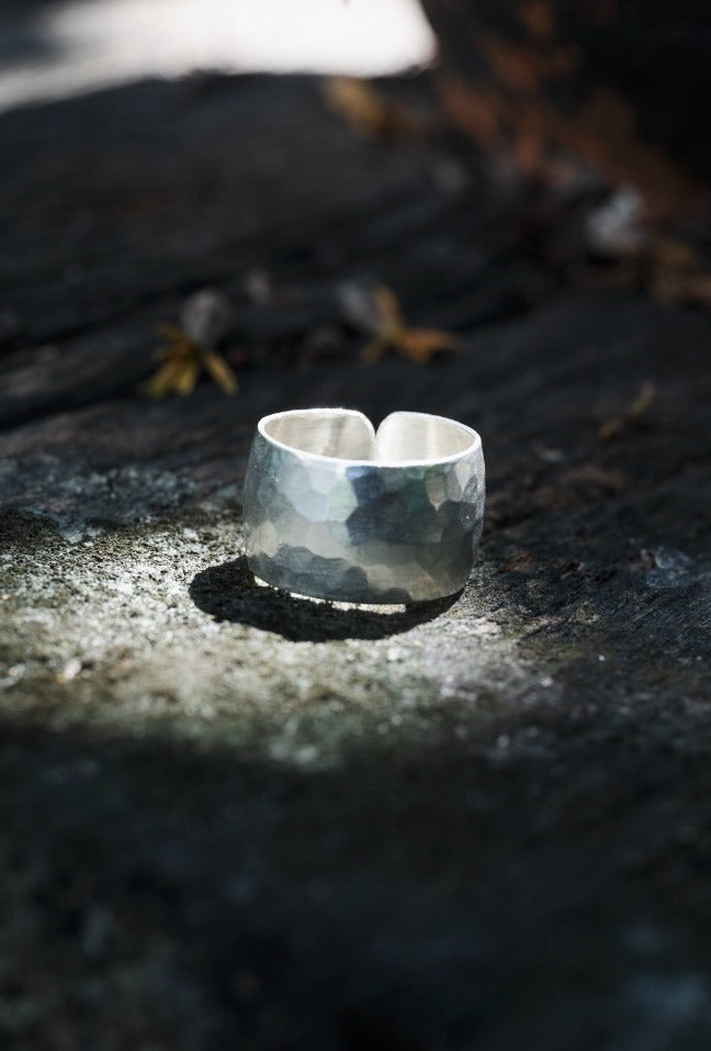 Silver ring on a textured stone surface